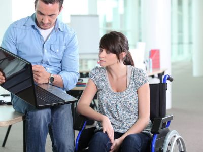Woman in Melbourne, FL discussing a Short Term Disability policy with a coworker